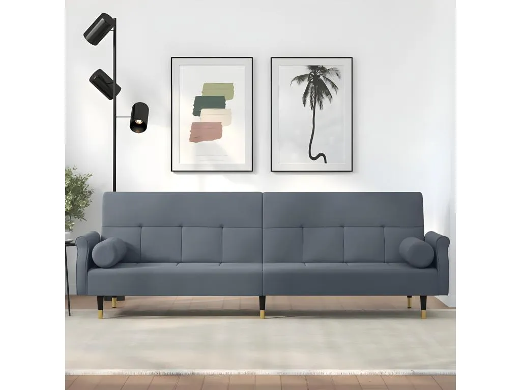 Sofá cama con cojines de terciopelo gris oscuro.